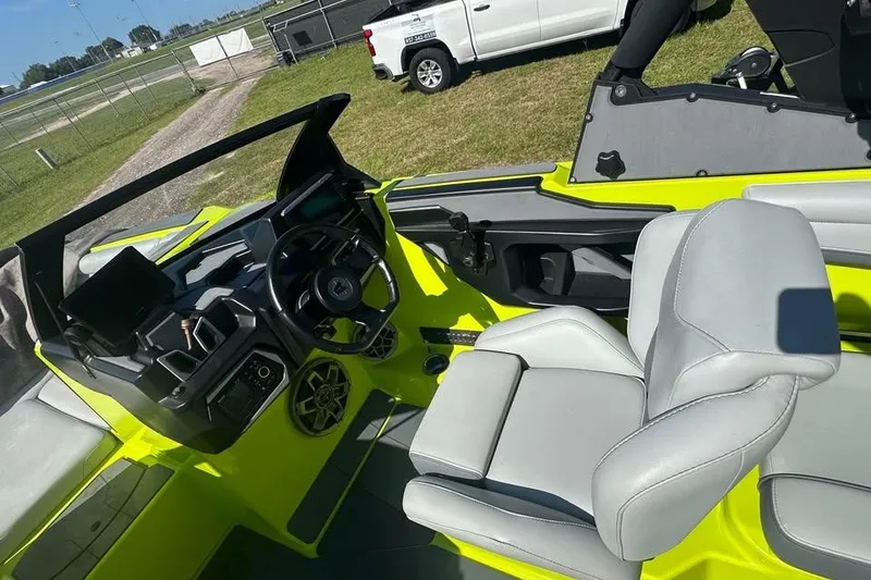 Slide: The Image of 2023 Axis A225 boat interior with modern dashboard and gray seating. - 4