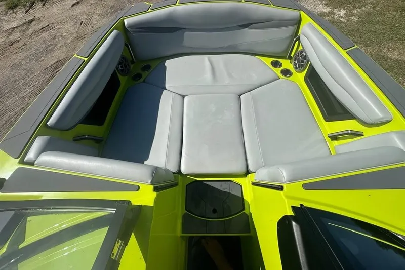 Slide: The Image of 2023 Axis A225 boat interior with gray seating and vibrant yellow accents. - 6