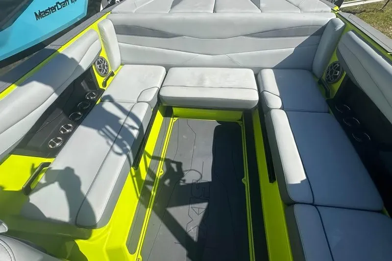 Slide: The Image of 2023 Axis A225 boat interior with gray seating and vibrant yellow accents. - 7