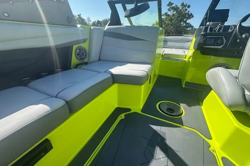 Slide: The Image of 2023 Axis A225 boat interior with gray seating and vibrant yellow accents. - 8