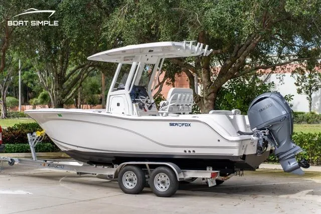 Slide: The Image of 2026 Sea Fox 228 Commander boat on trailer, parked outdoors. - 2