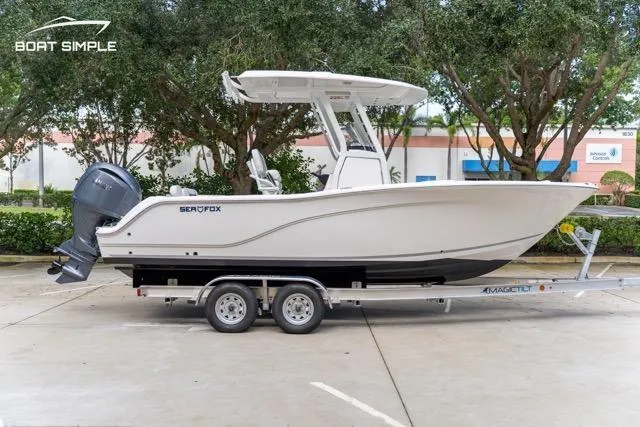 Slide: The Image of 2026 Sea Fox 228 Commander boat on trailer, parked outdoors. - 5