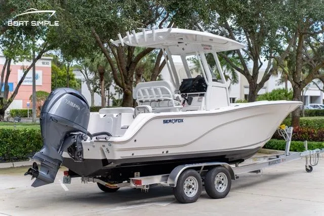 Slide: The Image of 2026 Sea Fox 228 Commander boat on trailer, parked outdoors. - 3