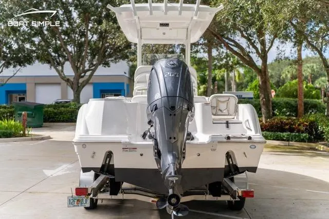 Slide: The Image of 2026 Sea Fox 228 Commander boat with Yamaha engine, parked outdoors. - 7