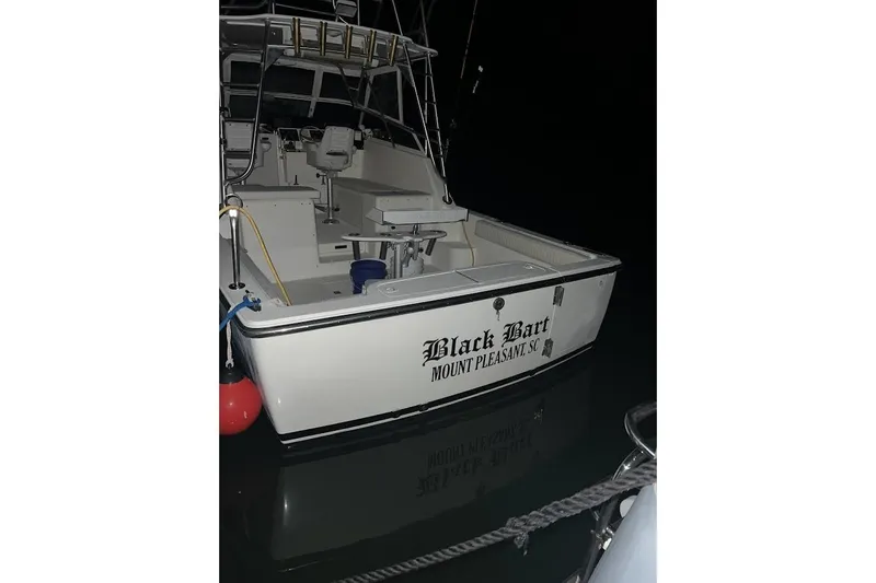 Slide: The Image of 1998 Henriques 28 Express boat docked at night, named "Black Bart," Mount Pleasant, SC. - 14
