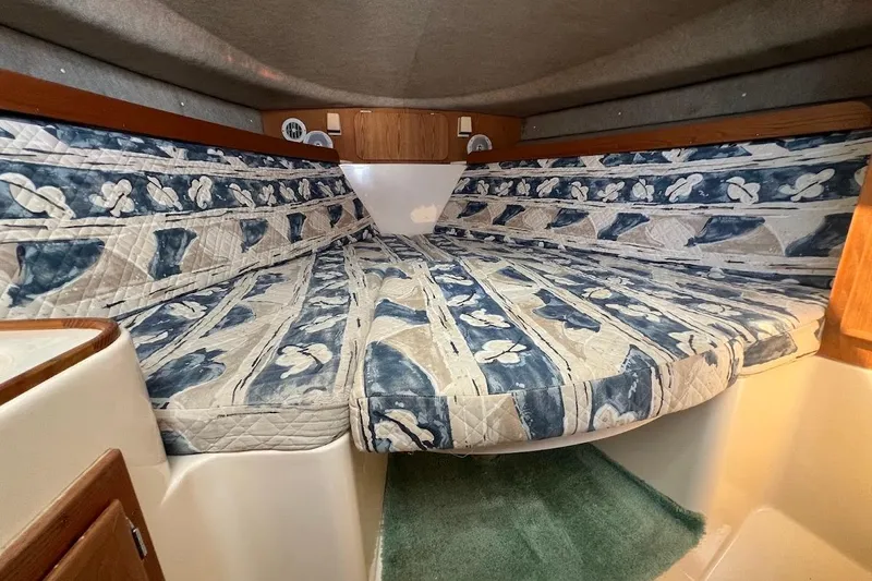 Slide: The Image of 1998 Henriques 28 Express cabin with floral-patterned bedding and wood accents. - 6