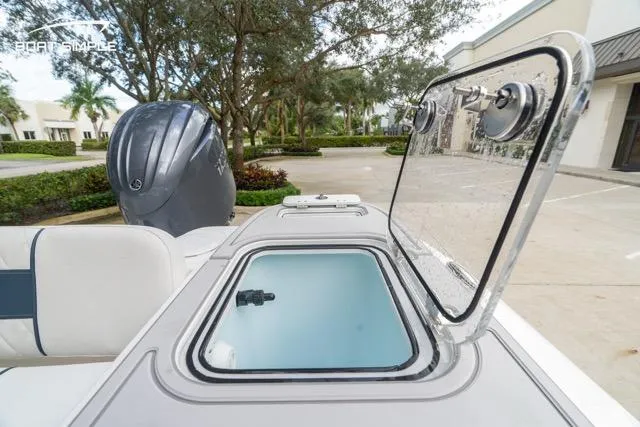 Slide: The Image of 2026 Sea Fox 228 Commander boat with open storage compartment and visible outboard motor. - 18