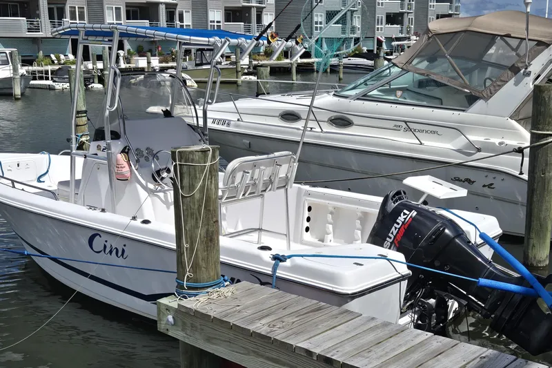 Slide: The Image of 2008 Pro-Line 21 Sport Center Console boat docked at marina with Suzuki outboard motor. - 1