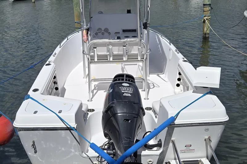 Slide: The Image of 2008 Pro-Line 21 Sport Center Console boat with Suzuki 140 outboard motor docked. - 2