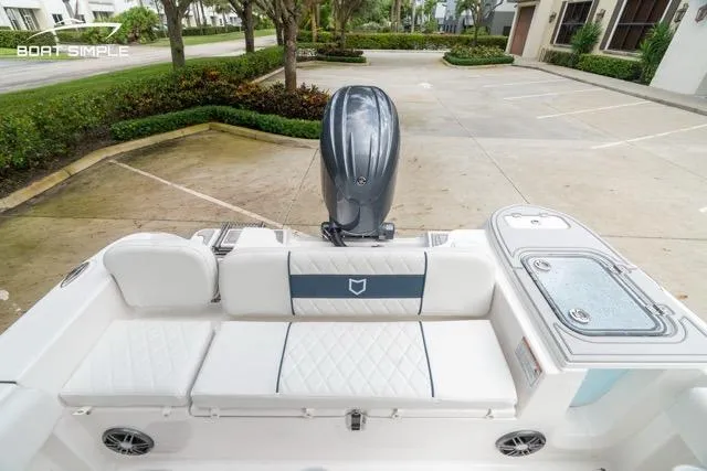 Slide: The Image of 2026 Sea Fox 228 Commander boat interior with seating and motor in a parking area. - 20