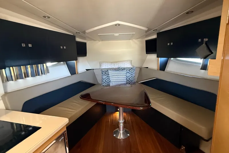 Slide: The Image of 2013 Pursuit SC 365i Sport Coupe interior with cozy seating and elegant table. - 16