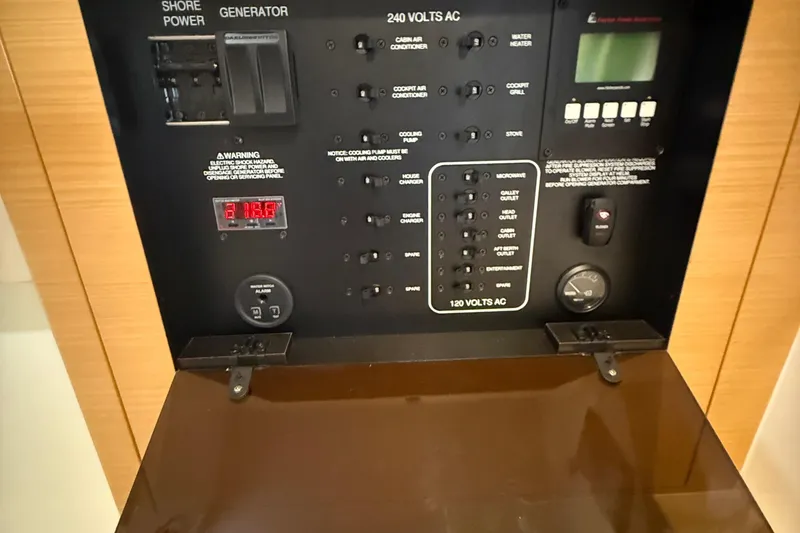 Slide: The Image of Control panel of a 2013 Pursuit SC 365i Sport Coupe, featuring various electrical switches. - 18