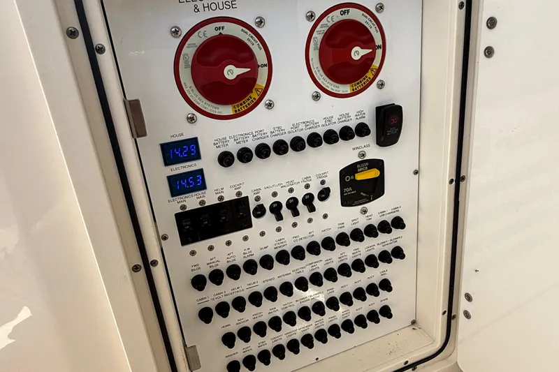 Slide: The Image of Electrical control panel of 2013 Pursuit SC 365i Sport Coupe boat, featuring switches and digital displays. - 20