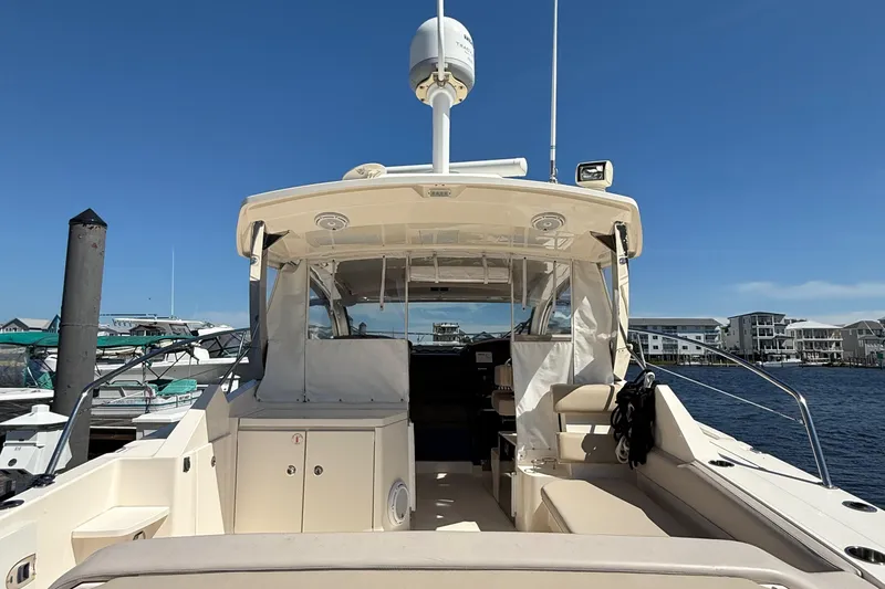 Slide: The Image of 2013 Pursuit SC 365i Sport Coupe docked at marina under clear blue sky. - 8
