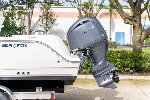 Slide: The Image of 2026 Sea Fox 228 Commander boat with Yamaha outboard motor, parked outdoors. - 8