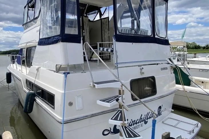 The Image of 1992 Carver 36 Aft Cabin yacht docked, featuring spacious deck and elegant design. - 0