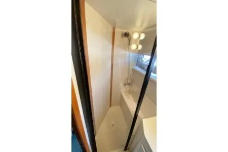 Slide: The Image of 1992 Carver 36 Aft Cabin bathroom with shower and vanity. - 14