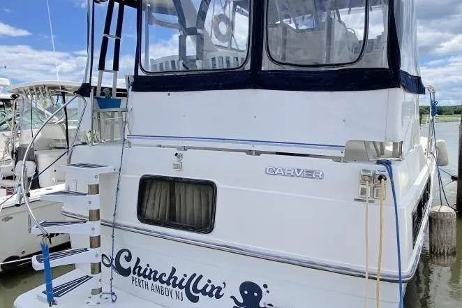 Slide: The Image of 1992 Carver 36 Aft Cabin boat docked, featuring "Chinchillin'" name and Perth Amboy, NJ location. - 16