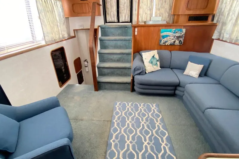 Slide: The Image of Interior of 1992 Carver 36 Aft Cabin with blue seating and nautical decor. - 2