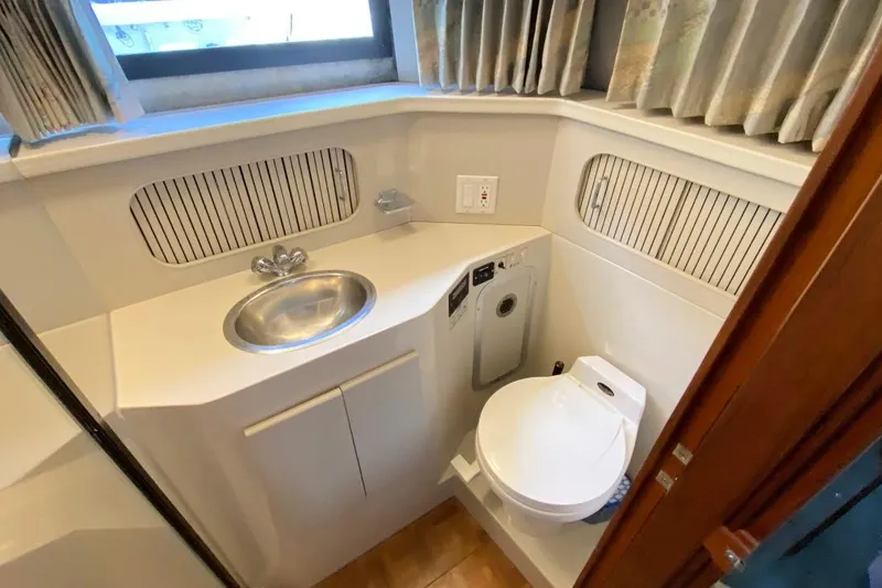 Slide: The Image of Compact bathroom in 1992 Carver 36 Aft Cabin yacht with sink and toilet. - 13