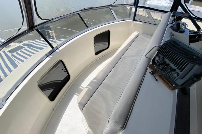 Slide: The Image of 1992 Carver 36 Aft Cabin boat interior with seating and control panel. - 22