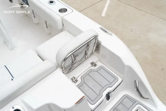 Slide: The Image of 2026 Sea Fox 228 Commander boat interior with white seating and storage compartments. - 16