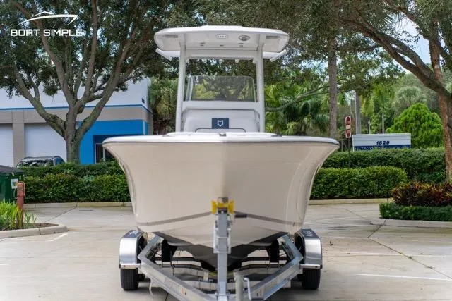 Slide: The Image of 2026 Sea Fox 228 Commander boat on trailer, parked outdoors with trees in background. - 6