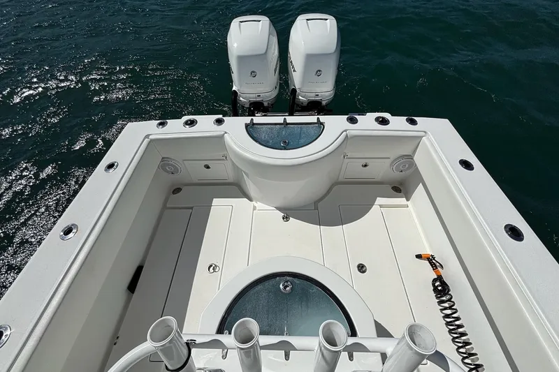 Slide: The Image of 2016 Onslow Bay 27 XS boat deck with dual engines on water. - 13
