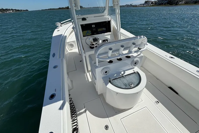Slide: The Image of 2016 Onslow Bay 27 XS boat on water, featuring center console and rod holders. - 18