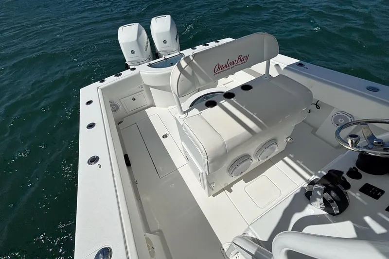 Slide: The Image of 2016 Onslow Bay 27 XS boat interior with dual engines on open water. - 19