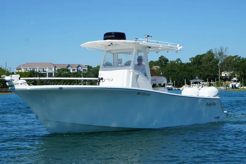 Slide: The Image of 2016 Onslow Bay 27 XS boat cruising on a sunny day near waterfront homes. - 7