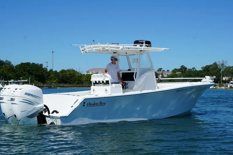 Slide: The Image of 2016 Onslow Bay 27 XS boat on water with dual Mercury engines. - 8