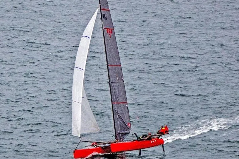 The Image of Sailing Marstrom MC 32 catamaran from 2011 gliding on open water. - 0
