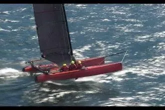 Slide: The Image of Red Marstrom MC 32 catamaran sailing swiftly on open water, 2011 model. - 4