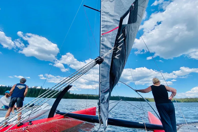 Slide: The Image of Sailing on a 2011 Marstrom MC 32 catamaran under a clear blue sky. - 6