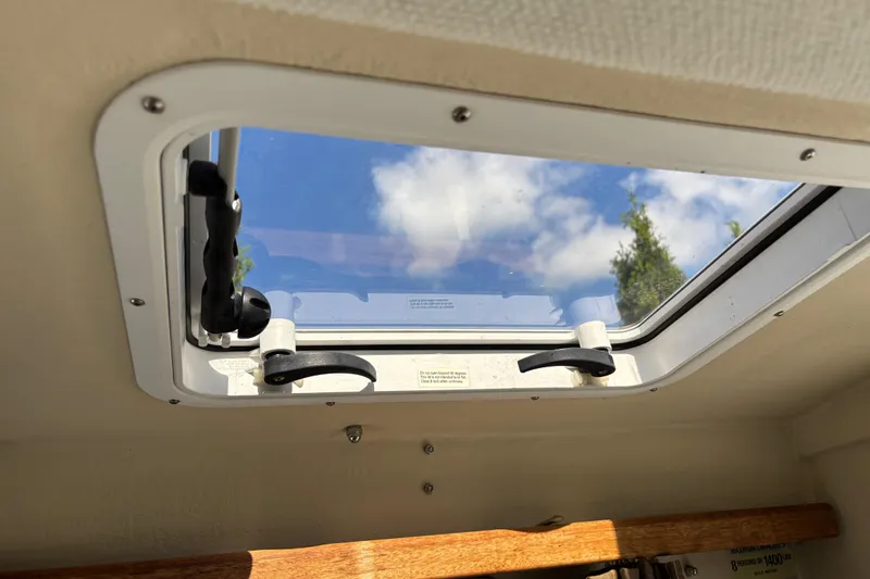 Slide: The Image of Skylight view from 2009 Ranger Tugs R-21 EC, showcasing blue sky and clouds. - 10