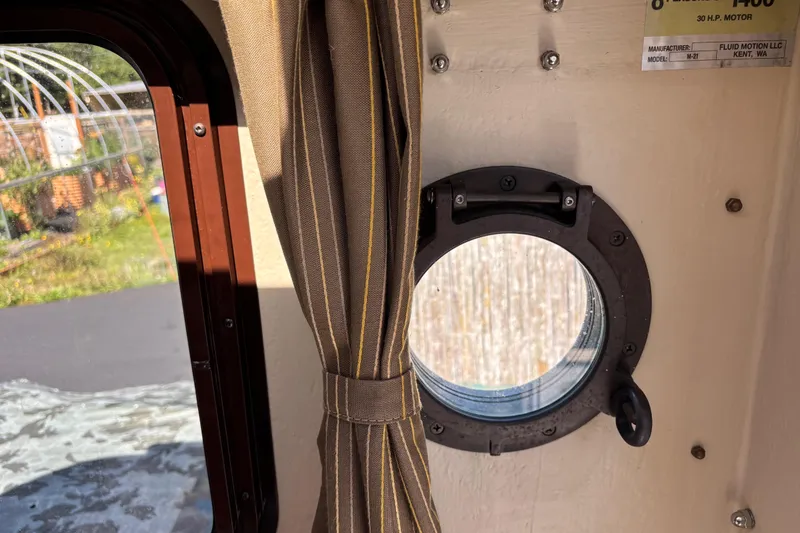 Slide: The Image of Interior view of 2009 Ranger Tugs R-21 EC with porthole and curtain. - 11