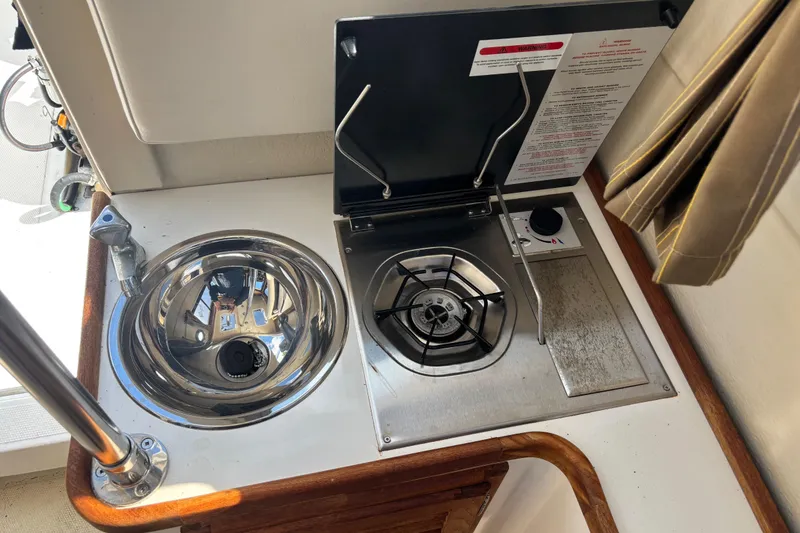 Slide: The Image of 2009 Ranger Tugs R-21 EC boat galley with sink and stove. - 15