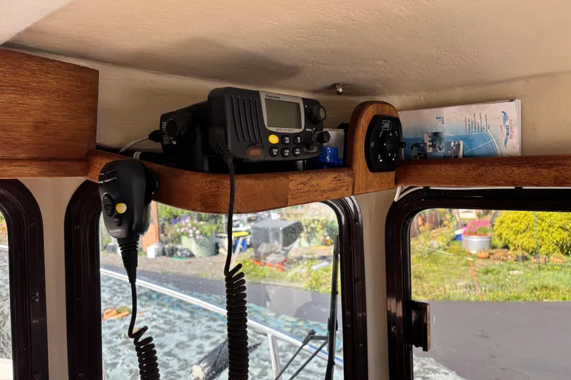 Slide: The Image of 2009 Ranger Tugs R-21 EC interior with radio equipment and wooden shelf. - 7