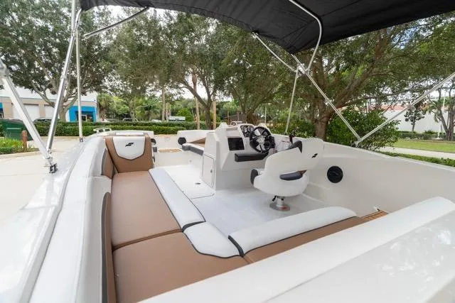 Slide: The Image of 2026 Starcraft SVX 211 OB boat interior with seating and steering console. - 14