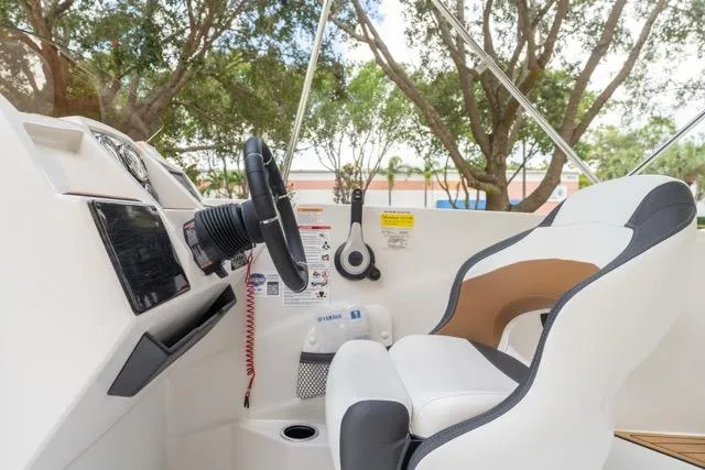 Slide: The Image of 2026 Starcraft SVX 211 OB boat interior with steering wheel and captain's chair. - 15