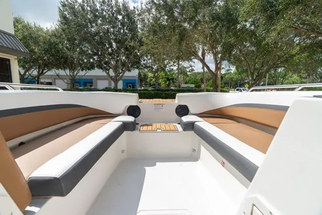 Slide: The Image of 2026 Starcraft SVX 211 OB boat interior with cushioned seating and scenic outdoor view. - 17