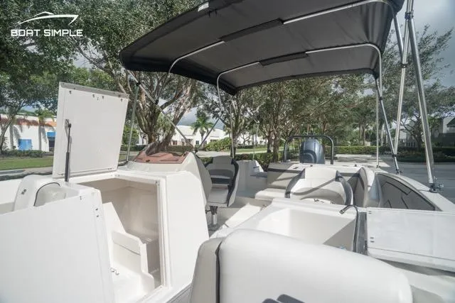 Slide: The Image of 2023 Starcraft SVX 231 OB DH boat interior with canopy and storage compartments. - 11