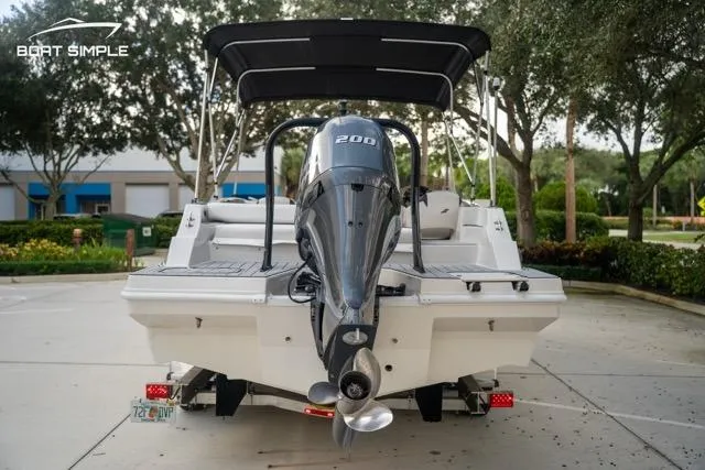Slide: The Image of 2023 Starcraft SVX 231 OB DH boat with outboard motor, parked outdoors. - 7
