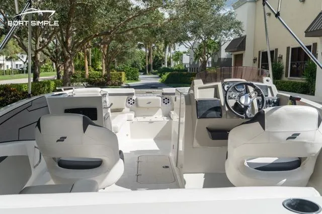 Slide: The Image of 2023 Starcraft SVX 231 OB DH boat interior with modern seating and steering wheel. - 16