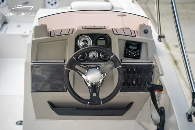 Slide: The Image of 2023 Starcraft SVX 231 OB DH boat dashboard with steering wheel and control panel. - 8
