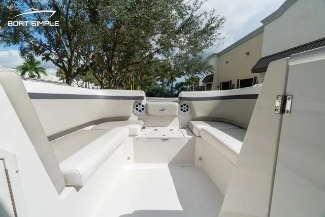 Slide: The Image of 2023 Starcraft SVX 231 OB DH boat interior with white seating and speakers. - 12
