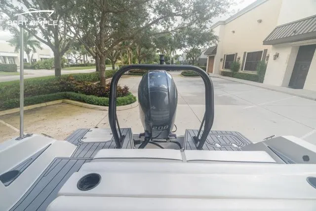 Slide: The Image of 2023 Starcraft SVX 231 OB DH boat with Yamaha 200 engine, parked outdoors. - 13