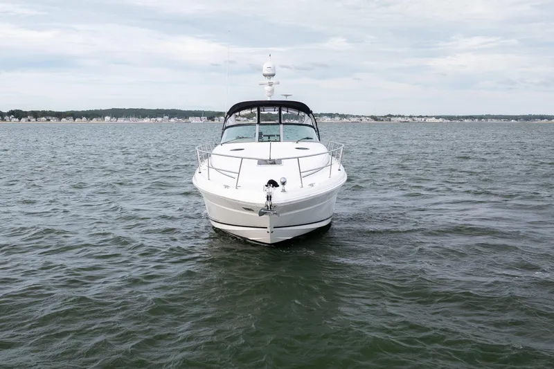 Slide: The Image of 2003 Sea Ray 360 Sundancer yacht on open water, front view. - 10