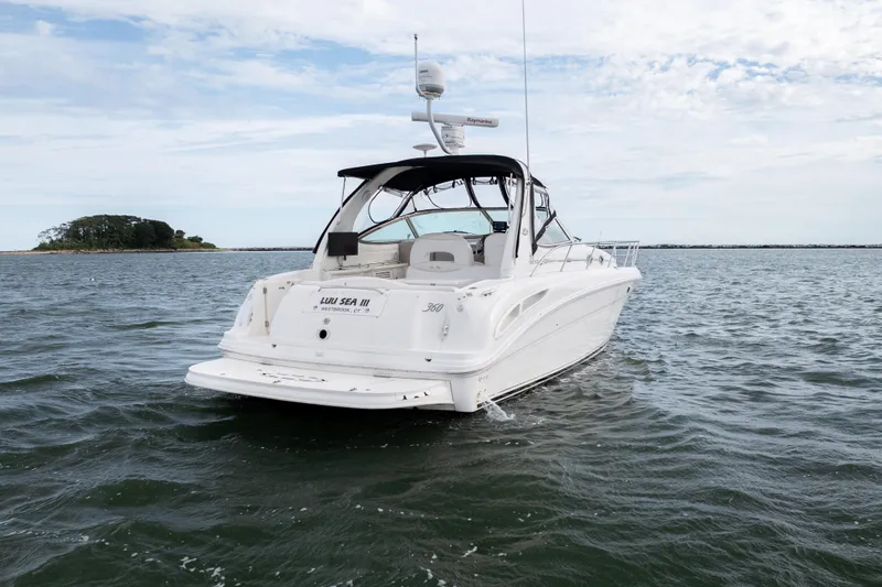 Slide: The Image of 2003 Sea Ray 360 Sundancer yacht on open water, rear view. - 12